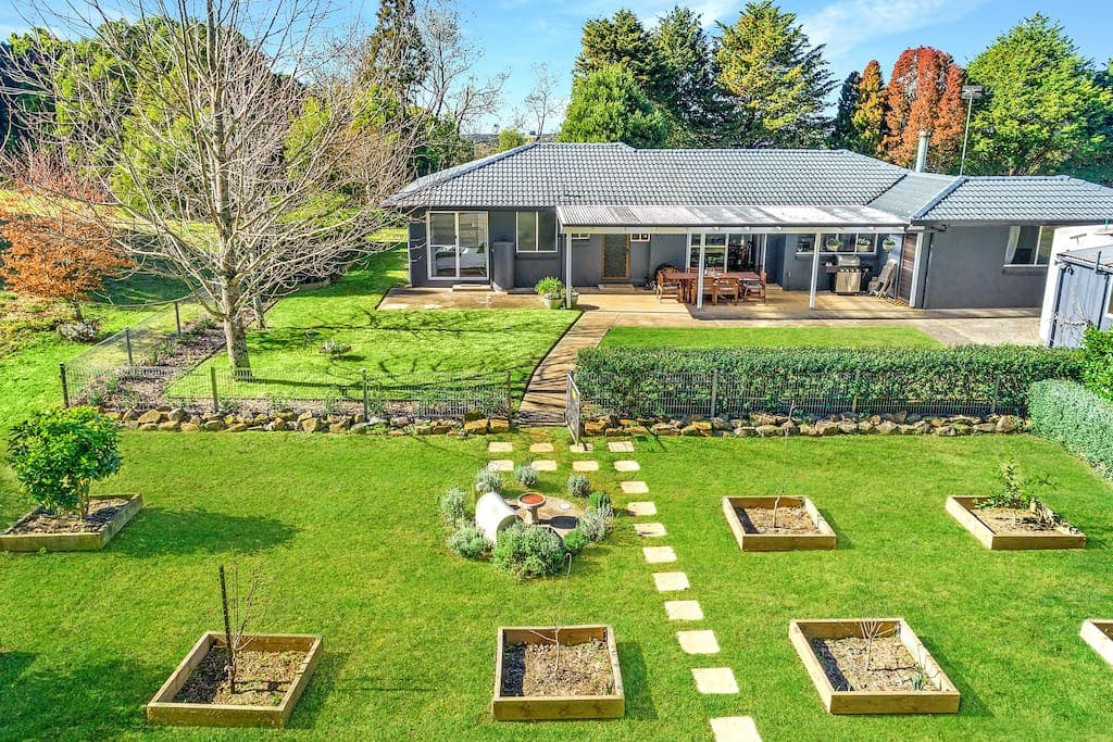 The beautiful, sun-lit backyard overlooks the orchard where you can help yourself to lemons, oranges and more. 